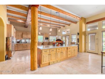 Large kitchen island, wood cabinets, and high ceilings at 6964 E Redbird Rd, Scottsdale, AZ 85266