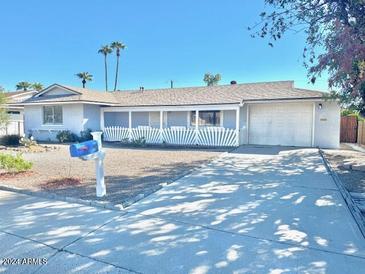 Ranch-style home with a carport and well-maintained yard at 11439 N Hagen Dr, Sun City, AZ 85351