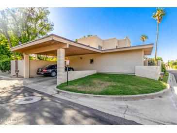 Covered carport with a single car and grassy area at 4525 N 66Th St # 70, Scottsdale, AZ 85251