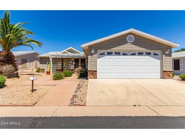 Single-story home with attached garage and desert landscaping at 2550 S Ellsworth Rd # 366, Mesa, AZ 85209