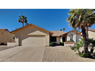 Single-story home with a two-car garage and desert landscaping at 9623 W Wescott Dr, Peoria, AZ 85382