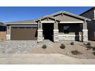 Single-story home with a two-car garage and stone accents at 40500 W Wade Dr, Maricopa, AZ 85138