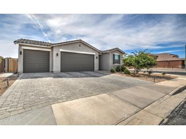 Two-story home with a two-car garage and paver driveway at 1859 N Westfall Ln, Casa Grande, AZ 85122