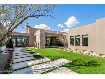 Landscaped backyard featuring a modern home with stone accents at 24046 N 126Th Pl, Scottsdale, AZ 85255