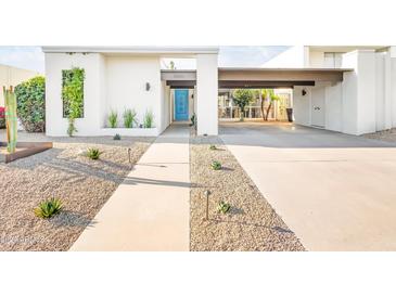 Modern home exterior with blue door and gravel landscaping at 8634 E Monterosa Ave, Scottsdale, AZ 85251