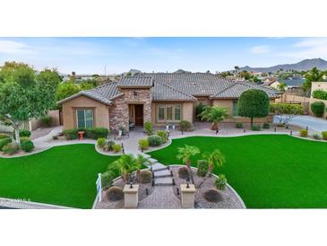Stunning home with a lush green lawn and mountain views at 7054 E Ingram St, Mesa, AZ 85207