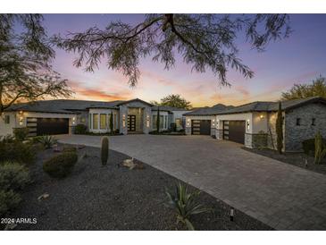 Luxury home exterior at dusk with a large driveway at 12312 E Shangri La Rd, Scottsdale, AZ 85259