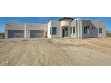 Modern home exterior with a two car garage and desert landscaping at 38718 N 24Th Ave, Phoenix, AZ 85086