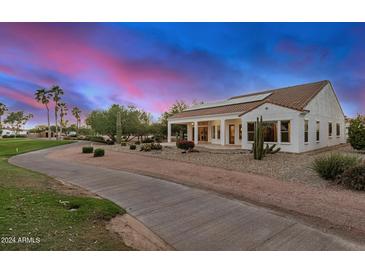 Single-story home with a golf course view and solar panels at 16401 W Monterey Way, Goodyear, AZ 85395