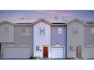 Modern two-story townhome with gray and white exterior, red door, and attached garage at 7577 W Darrow St, Laveen, AZ 85339