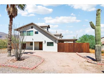 Two-story home with desert landscaping and wooden fence at 5599 S Alameda Rd, Gold Canyon, AZ 85118