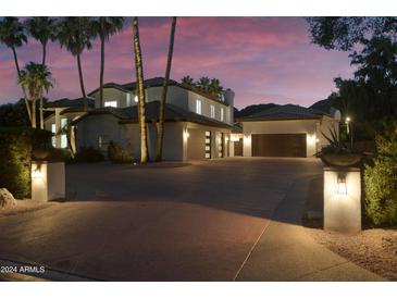 Luxury home with a large driveway at dusk at 9030 N 48Th Pl, Paradise Valley, AZ 85253