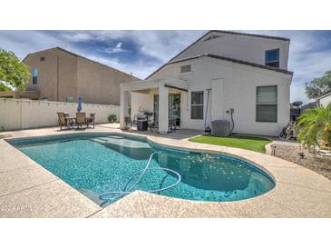 Inviting kidney-shaped pool in a well-maintained backyard setting at 3882 W Alabama Ln, San Tan Valley, AZ 85144