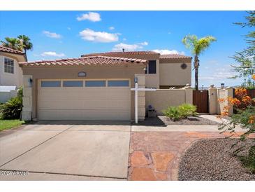 Two-story home with two-car garage and brick pathway at 3406 E Wildwood Dr, Phoenix, AZ 85048
