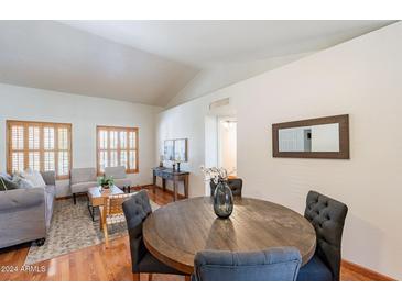 Bright dining room with wood table and chairs, hardwood floors, and access to living room at 14602 N Olympic Way, Fountain Hills, AZ 85268