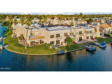 Aerial view of a waterfront property with boat slips and lush landscaping at 1438 W Coral Reef Dr, Gilbert, AZ 85233