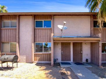 Two-unit building exterior with front yard and grill at 1750 E Mateo Cir # 103, Mesa, AZ 85204