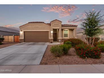 One-story home with brown garage door and landscaping at 285 S Espada Trl, Casa Grande, AZ 85194