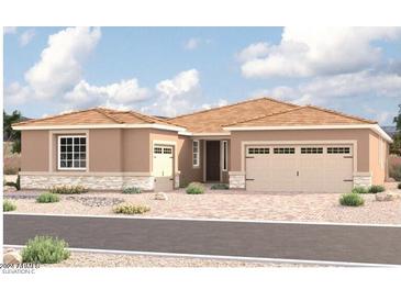 Tan two-story house with a three-car garage at 10512 S 48Th Gln, Laveen, AZ 85339