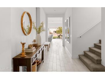 Bright and airy entryway with tile flooring, a console table, and views to the backyard at 20948 E Arrowhead Trl, Queen Creek, AZ 85142