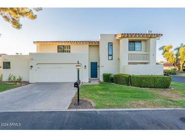 Two-story home with Spanish-style architecture and landscaped yard at 7344 E Keim Dr, Scottsdale, AZ 85250