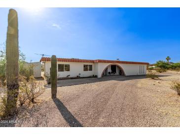 Ranch-style home with arched entryway and desert landscaping at 11801 S 193Rd Dr, Buckeye, AZ 85326