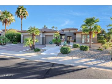 Single-story home with a two-car garage and manicured landscaping at 19232 N Cathedral Point Ct, Surprise, AZ 85387