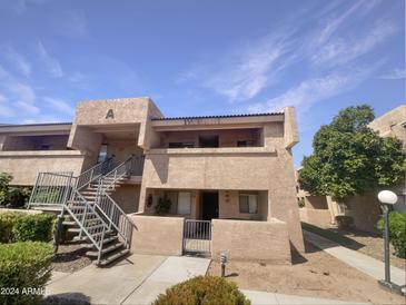 Two-story building exterior with stairs and landscaping at 10828 N Biltmore Dr # 203, Phoenix, AZ 85029