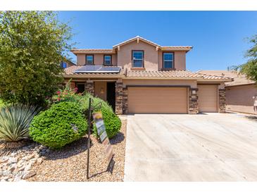 Two-story house with solar panels, three car garage, and landscaped front yard at 4506 W Maggie Dr, San Tan Valley, AZ 85144