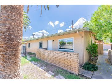 Ranch style home with a brick facade and walkway at 4943 E Indian School Rd # 4, Phoenix, AZ 85018