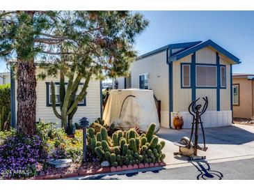 Mobile home exterior with landscaping and cacti at 17200 W Bell Rd # 188, Surprise, AZ 85374