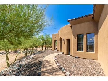 Charming home with stone pathway and desert landscaping at 16738 E Lone Mountain Rd, Scottsdale, AZ 85262
