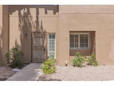 Condo exterior featuring a private entrance and landscaping at 500 N Gila Springs Blvd # 128, Chandler, AZ 85226