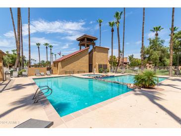 Community pool with surrounding lounge chairs at 4901 S Calle Los Cerros Dr # 267, Tempe, AZ 85282