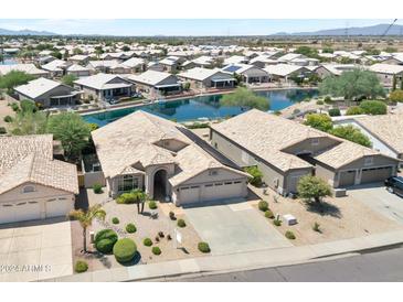 Home near a lake in a residential community at 10923 W Escuda Dr, Sun City, AZ 85373