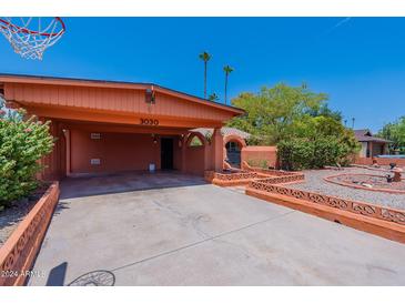 Carport and front yard view of a single story home at 3030 W Clinton St, Phoenix, AZ 85029