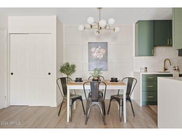 Bright dining area with a modern kitchen and stylish light fixture at 7350 N Via Paseo Del Sur -- # P202, Scottsdale, AZ 85258