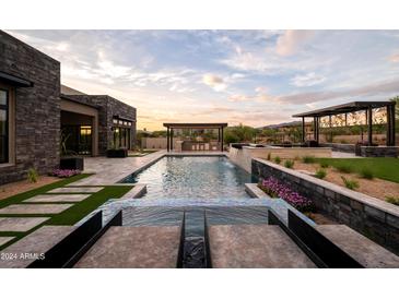 Luxury backyard oasis with a large pool and waterfall feature at 8332 E Sand Flower Dr # 20, Scottsdale, AZ 85266
