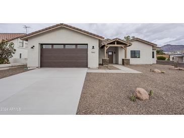 Newly constructed home with a two-car garage and desert landscaping at 9462 E Mogollon Trl, Gold Canyon, AZ 85118