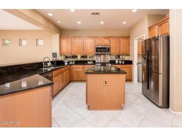 Spacious kitchen with island, stainless steel appliances, and granite counters at 13747 W Nogales Dr, Sun City West, AZ 85375