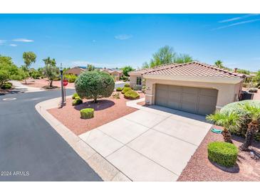 Single-story home with a two-car garage and nicely landscaped front yard at 13747 W Nogales Dr, Sun City West, AZ 85375