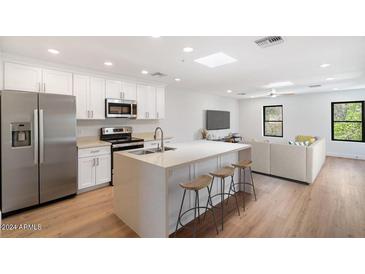 Modern kitchen with island, stainless steel appliances, and white cabinets at 16844 E Ave Of The Fountains -- # 201, Fountain Hills, AZ 85268