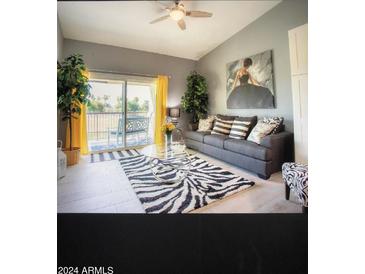 Bright living room with zebra rug and balcony access at 7101 W Beardsley Rd # 452, Glendale, AZ 85308