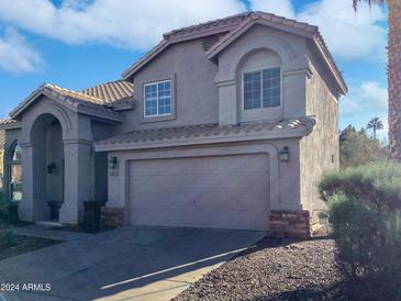 Two-story house with tile roof, arched entryway and two-car garage at 3815 E Wildwood Dr, Phoenix, AZ 85048