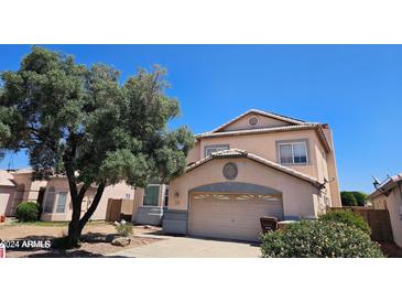 Two-story house with attached garage and mature tree at 16549 N 91St Dr, Peoria, AZ 85382