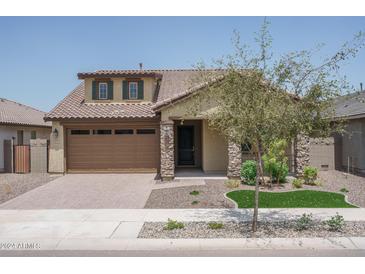 One-story home with a brown garage door and stone accents at 16172 W Alameda Rd, Surprise, AZ 85387