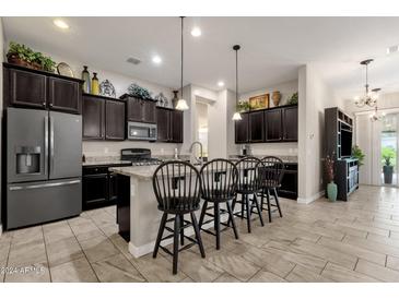 Open kitchen with island and breakfast bar seating at 2126 W Red Fox Rd, Phoenix, AZ 85085