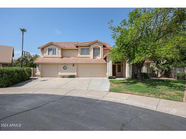 Two-story home with three-car garage and well-manicured lawn at 19422 N 67Th Ln, Glendale, AZ 85308