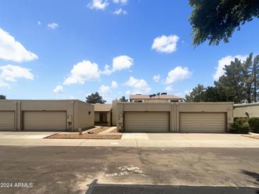 Front view of a townhome complex with attached garages at 2617 W Willow Ave, Phoenix, AZ 85029
