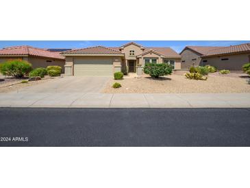 Single story home with attached garage and desert landscaping at 18000 N Estrella Vista Dr, Surprise, AZ 85374